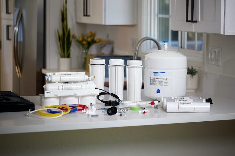Water filtration system on a kitchen counter with various components.