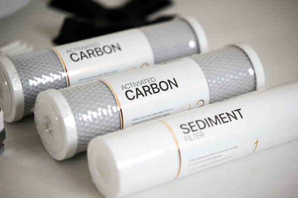 Three rolls of ro water replacement filter labeled 'Activated Carbon' and 'Sediment' on a white surface.
